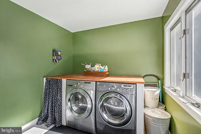 a spacious bathroom with a tub sink and mirror