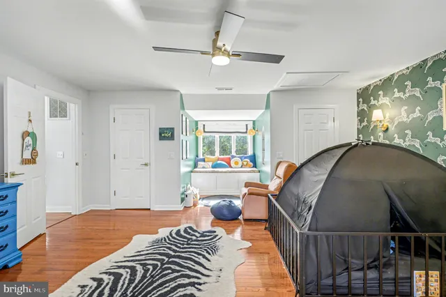 a view of a livingroom with workspace and a window