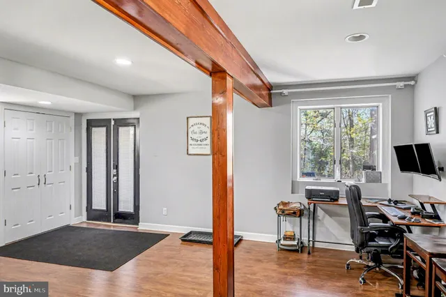 a front view of a house with a yard and trees