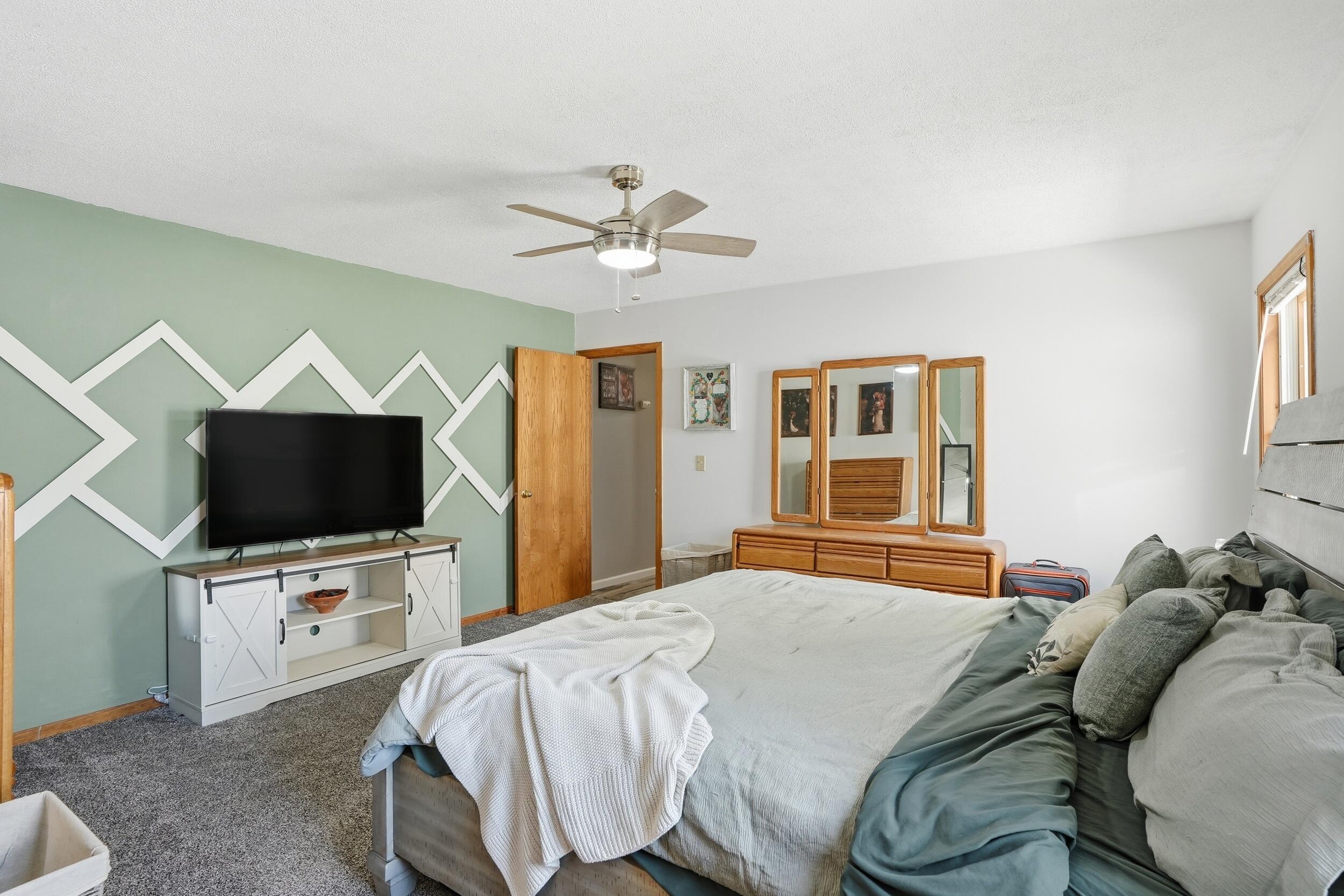 705 East Grace Street Rensselaer, IN 47978 - Photo 11 of 32 a bedroom with a bed and a flat screen tv