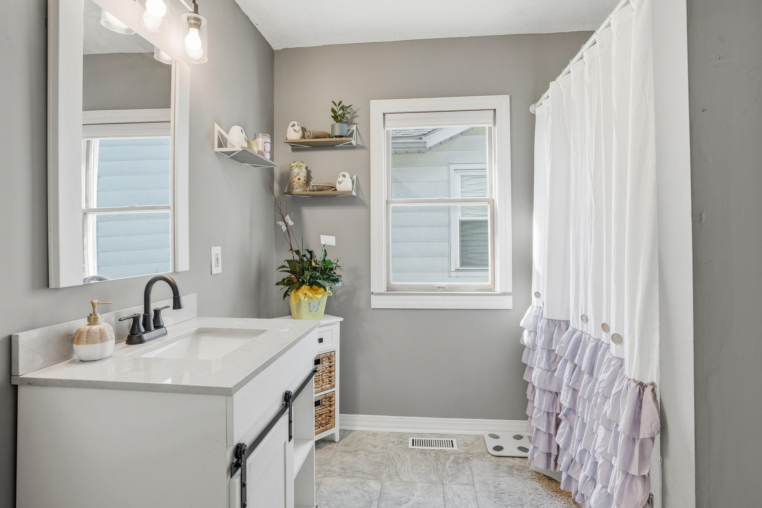 705 East Grace Street Rensselaer, IN 47978 - Photo 14 of 32 a bathroom with a sink and a mirror