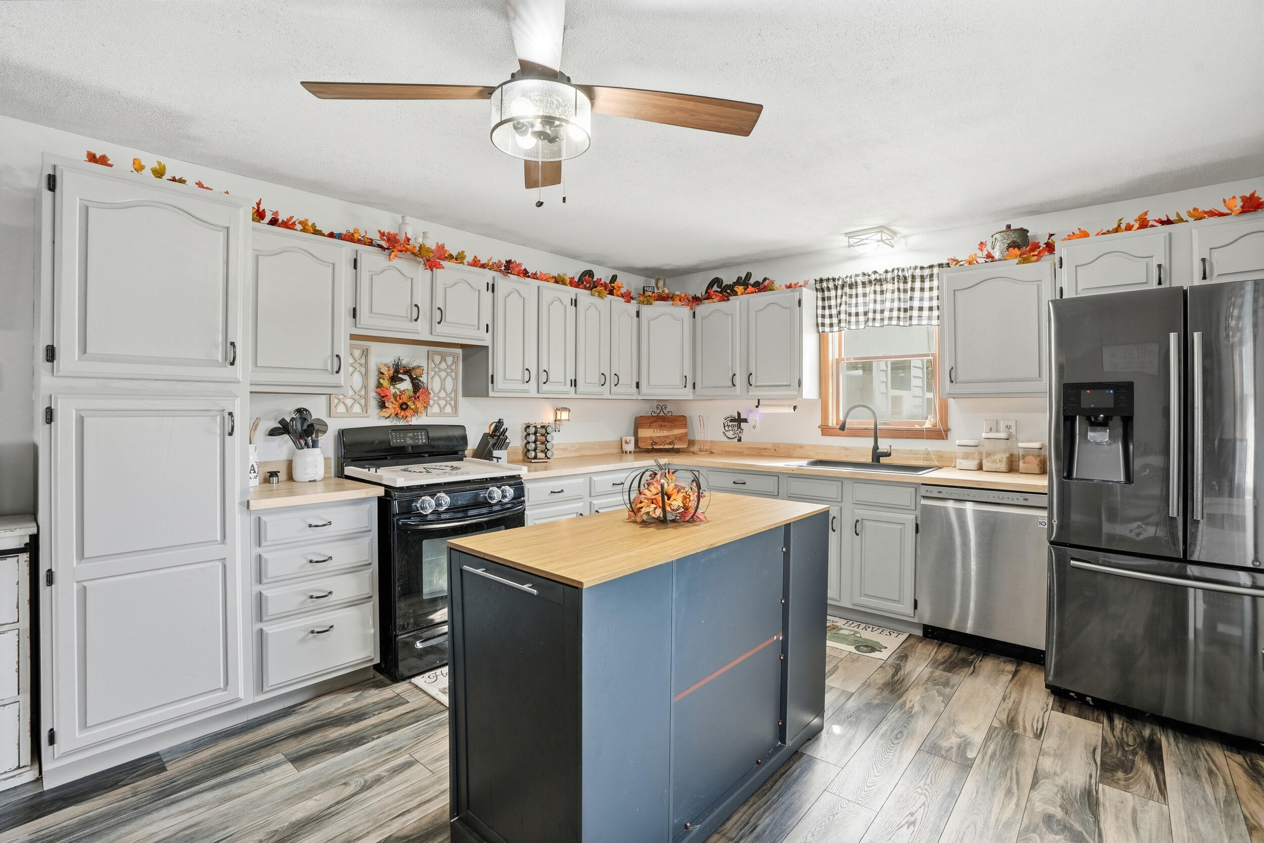 705 East Grace Street Rensselaer, IN 47978 - Photo 4 of 32 a kitchen with granite countertop a sink stainless steel appliances and white cabinets