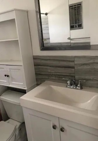 a bathroom with a toilet and a bathtub