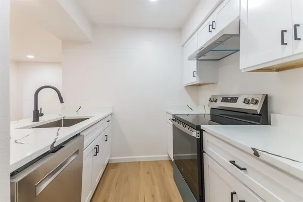 a kitchen with a sink and cabinets