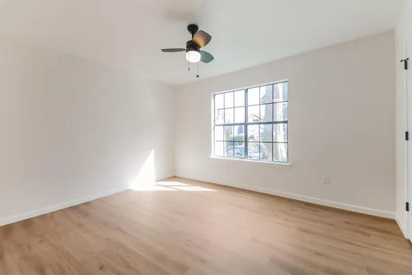 wooden floor in an empty room with a window