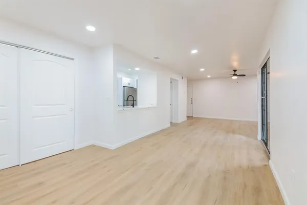 a view of an empty room with wooden floor