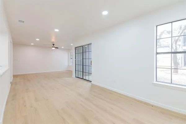 an empty room with windows and closet