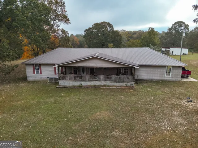 a house with swimming pool in front of it