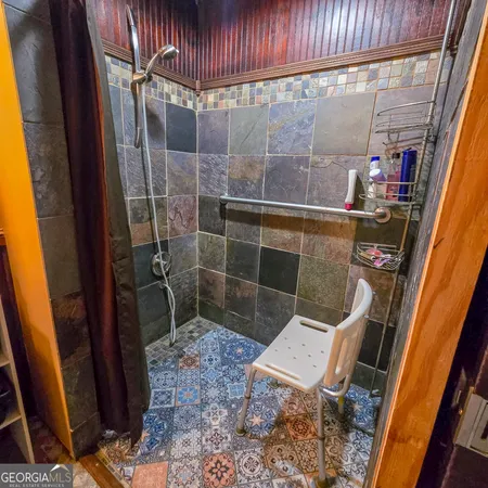 a bathroom with a toilet and a shower