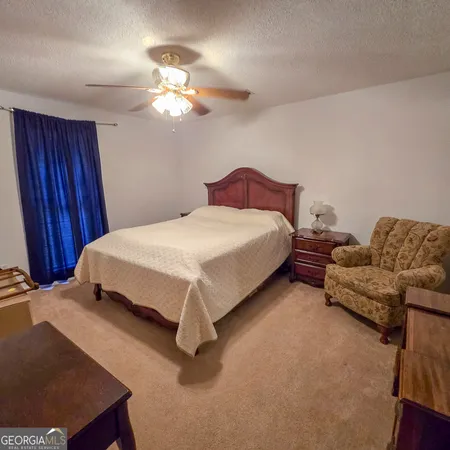 a bedroom with bed and a chandelier