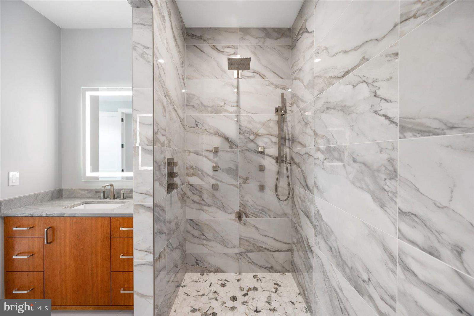12300 Snug Harbor Road Berlin, MD 21811 - Photo 16 of 28 a bathroom with a granite countertop sink a mirror and shower