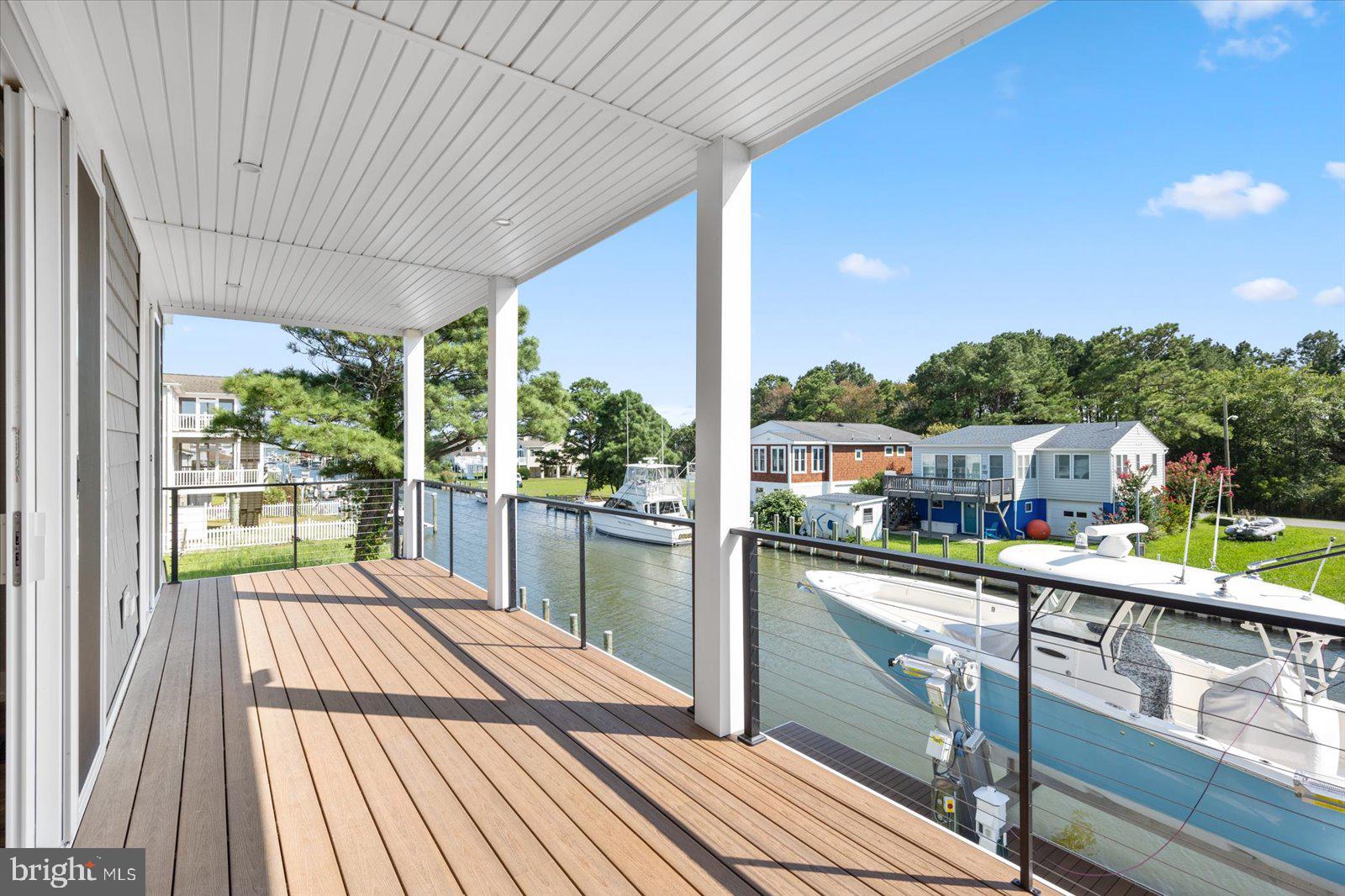 12300 Snug Harbor Road Berlin, MD 21811 - Photo 20 of 28 a view of a balcony with lake view and a floor to ceiling window