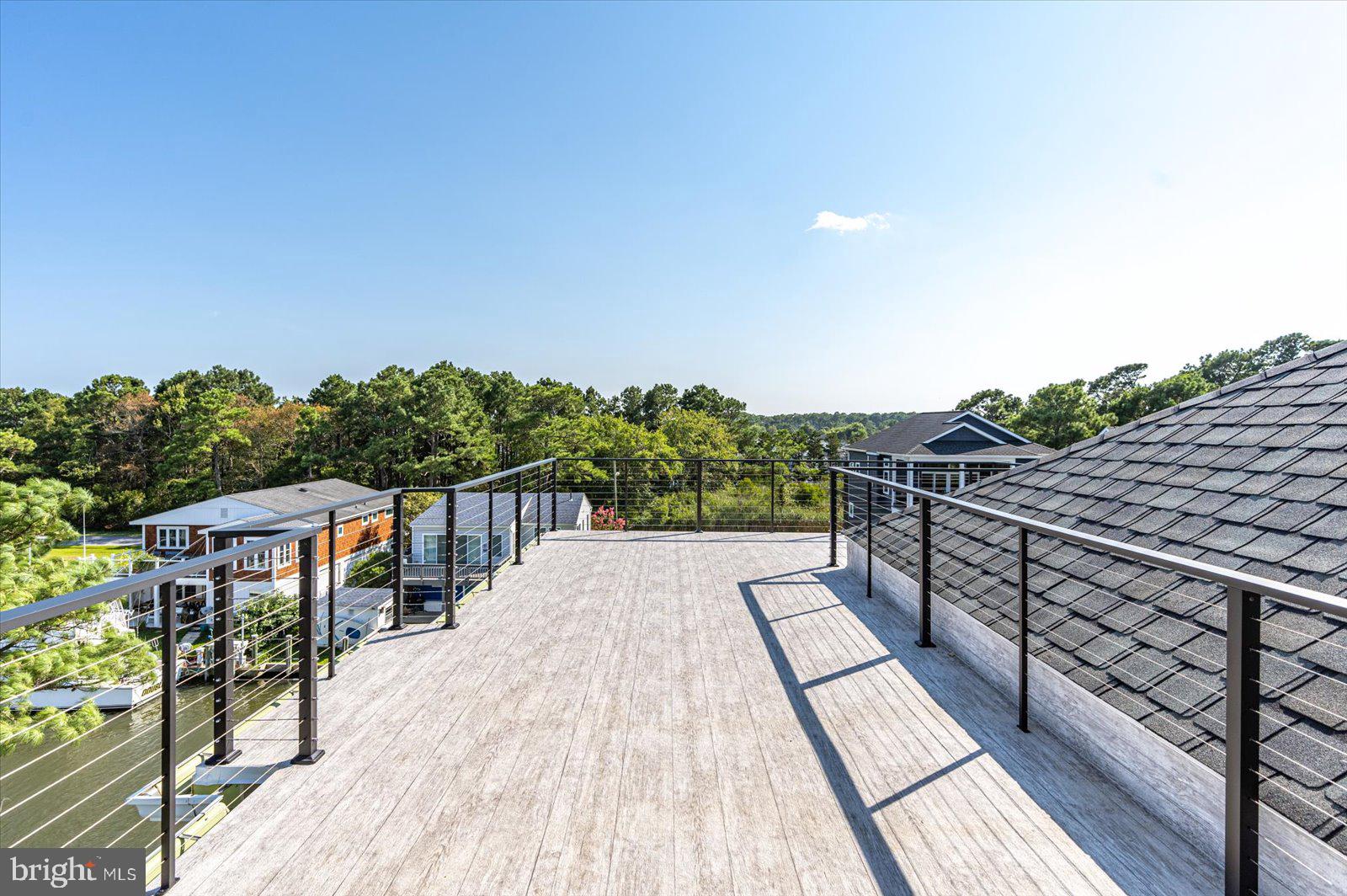 12300 Snug Harbor Road Berlin, MD 21811 - Photo 24 of 28 a balcony with wooden floor and city view