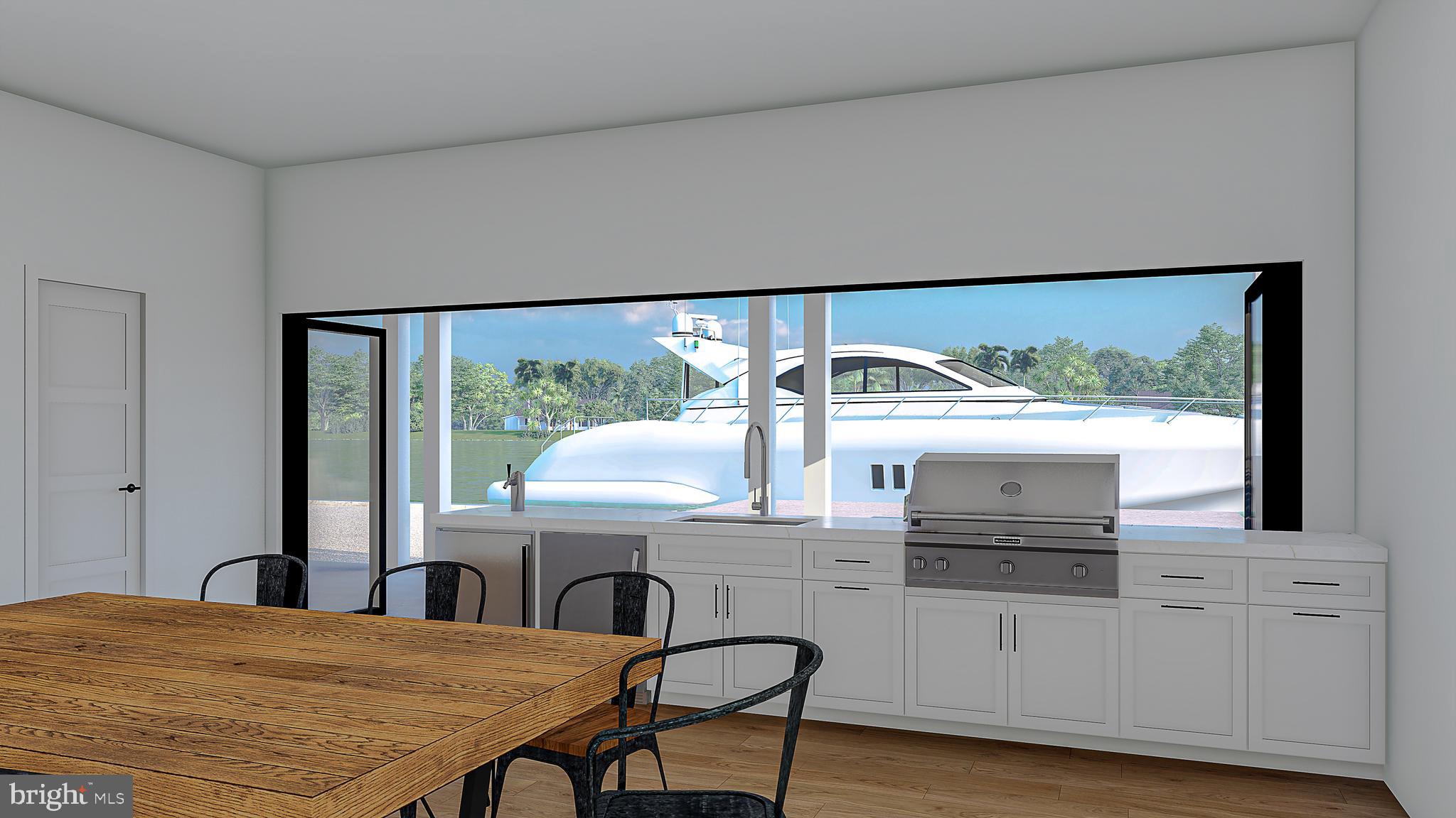 12300 Snug Harbor Road Berlin, MD 21811 - Photo 3 of 28 a kitchen with stainless steel appliances kitchen island a table chairs in it and wooden floor