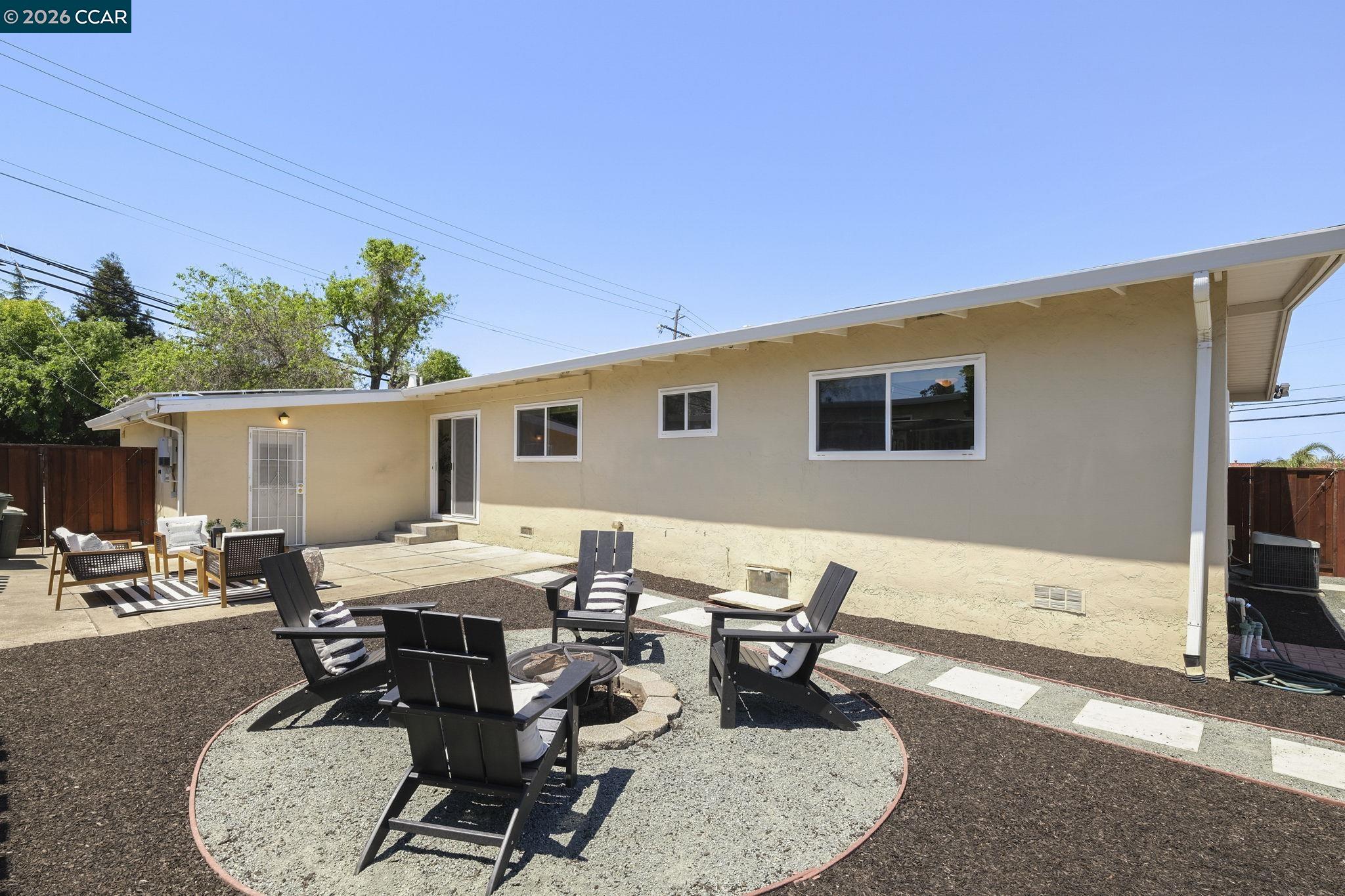 4311 Cowell Road Concord, CA 94521 - Photo 25 of 29 a view of a patio with table and chairs with wooden fence