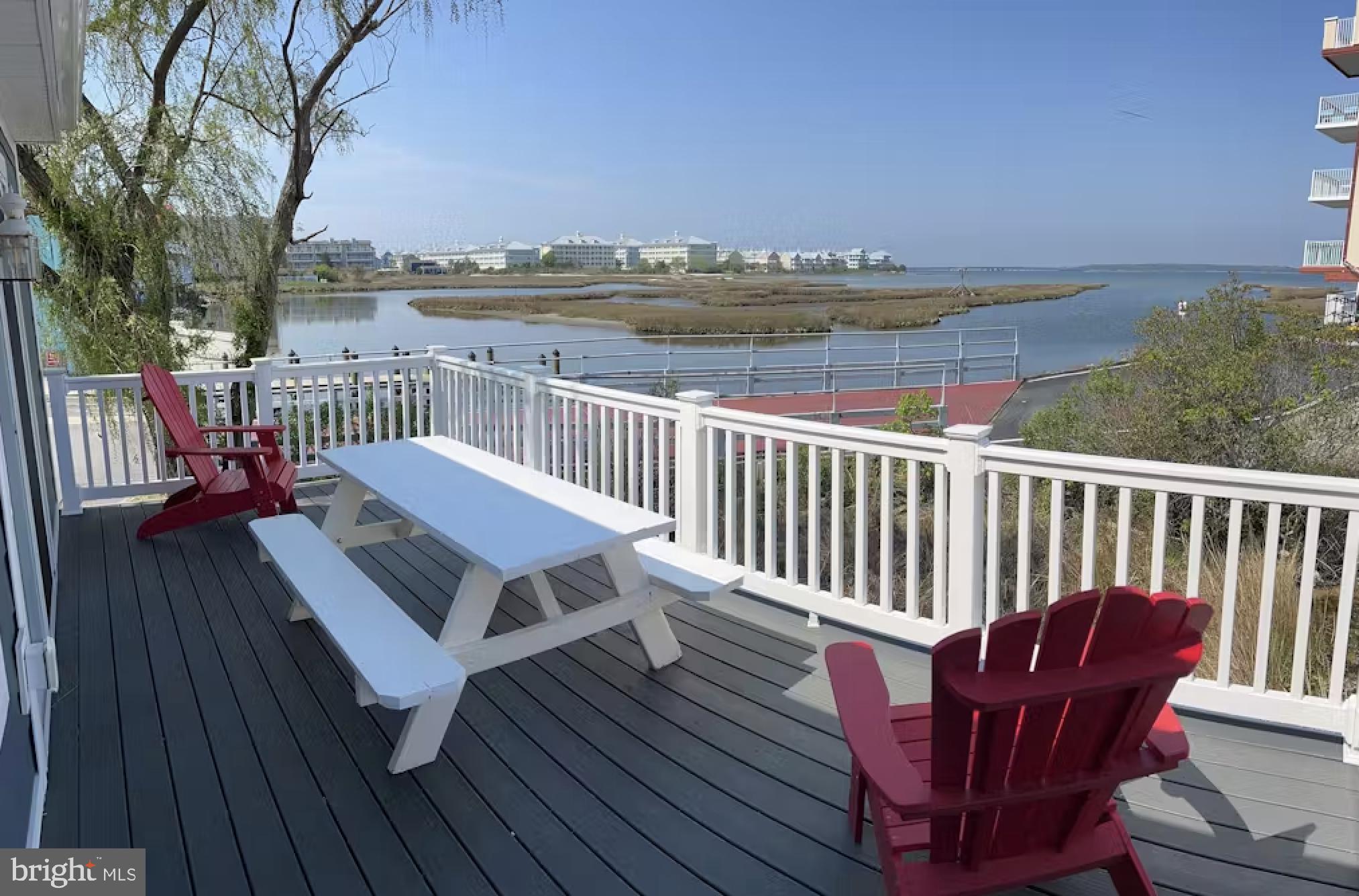 114 75th Street Ocean City, MD 21842 - Photo 6 of 11 a view of a balcony with wooden floor and outdoor seating