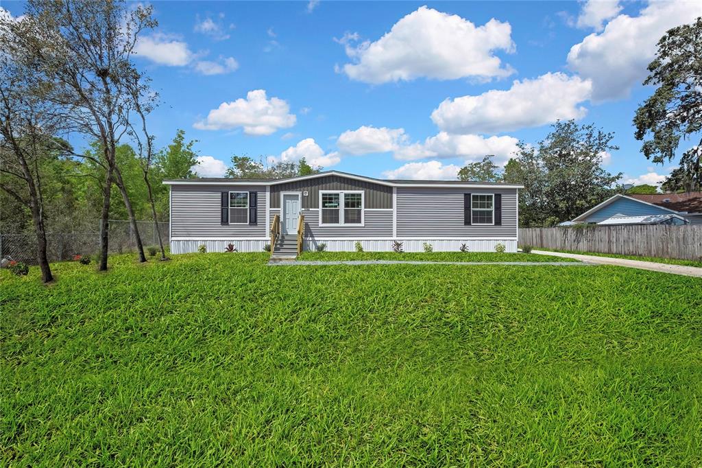 5342 South Isabel Terrace Homosassa, FL 34446 - Photo 1 of 23 a front view of a house with a garden and plants