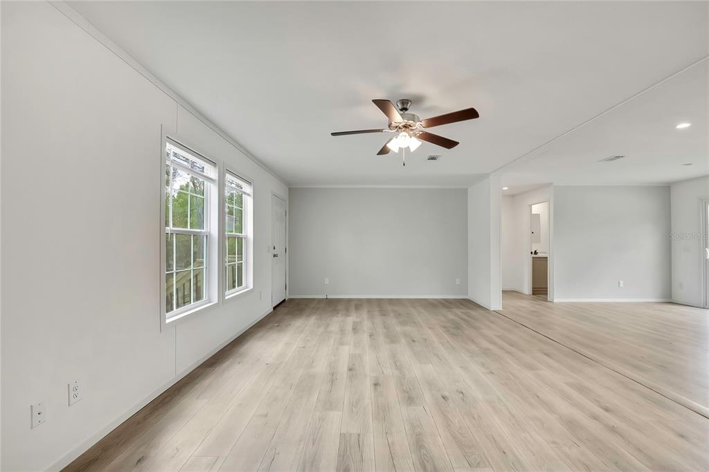5342 South Isabel Terrace Homosassa, FL 34446 - Photo 12 of 23 a view of an empty room with a window and wooden floor
