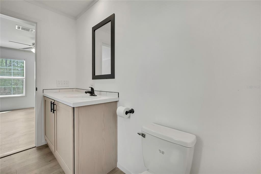 5342 South Isabel Terrace Homosassa, FL 34446 - Photo 18 of 23 a bathroom with a sink toilet and mirror