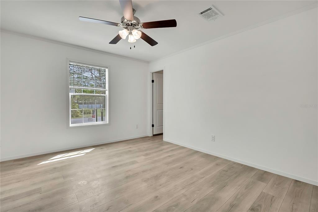 5342 South Isabel Terrace Homosassa, FL 34446 - Photo 19 of 23 an empty room with a window and a fan