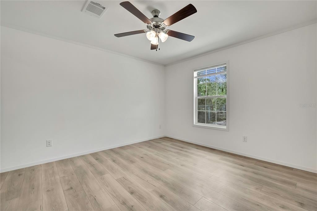 5342 South Isabel Terrace Homosassa, FL 34446 - Photo 21 of 23 an empty room with windows and fan