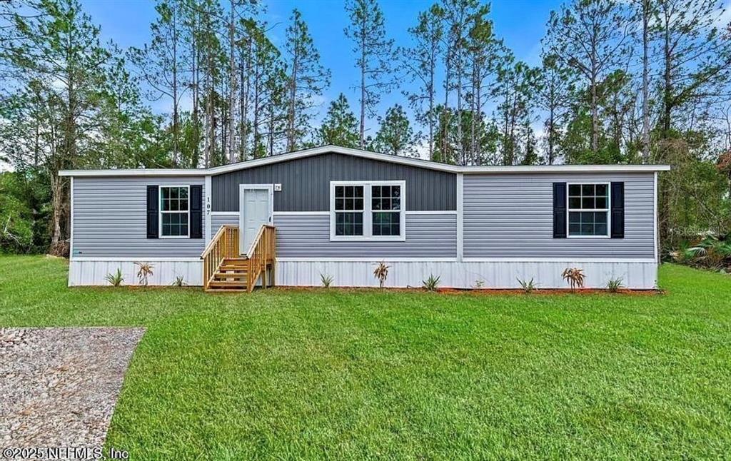 5342 South Isabel Terrace Homosassa, FL 34446 - Photo 23 of 23 a view of a house with a yard and deck