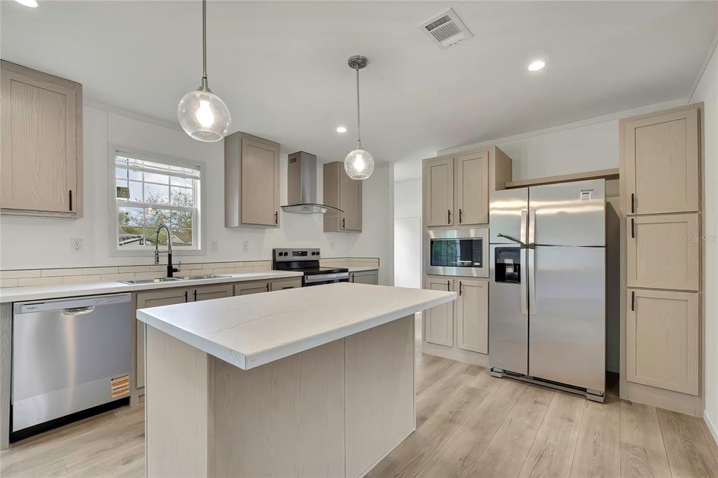 5342 South Isabel Terrace Homosassa, FL 34446 - Photo 4 of 23 a kitchen with stainless steel appliances a refrigerator a sink and a stove