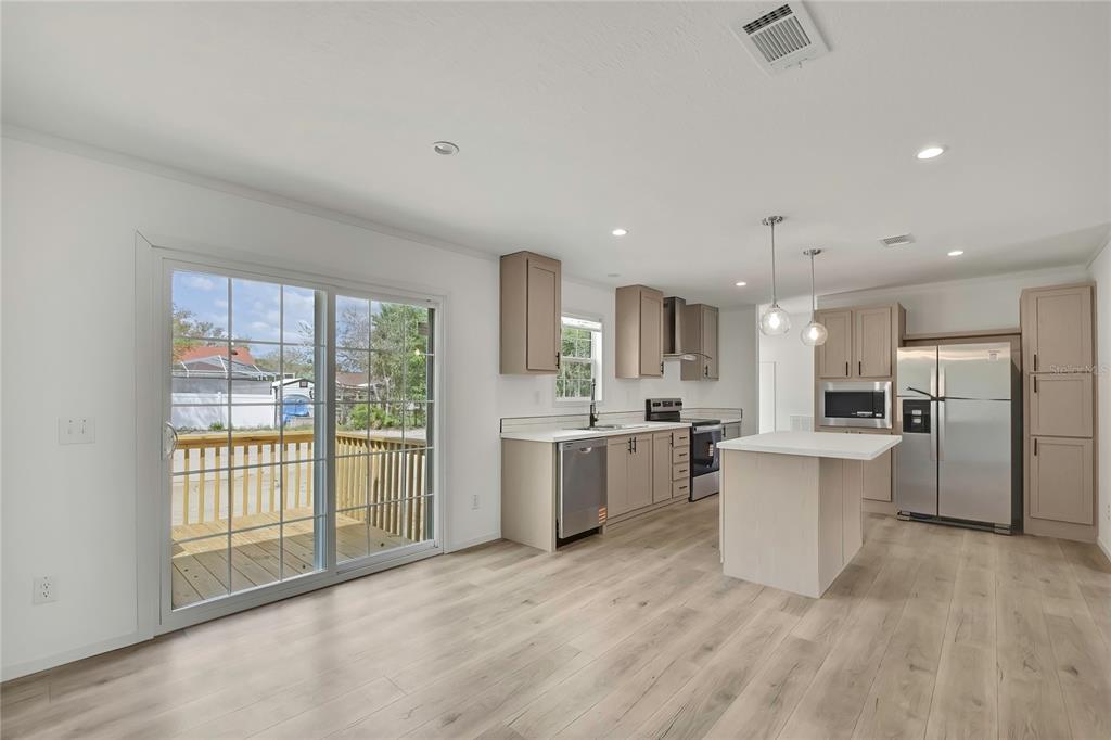 5342 South Isabel Terrace Homosassa, FL 34446 - Photo 5 of 23 a large white kitchen with a large window appliances and cabinets