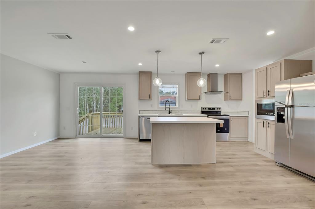5342 South Isabel Terrace Homosassa, FL 34446 - Photo 6 of 23 a open kitchen with white cabinets and stainless steel appliances