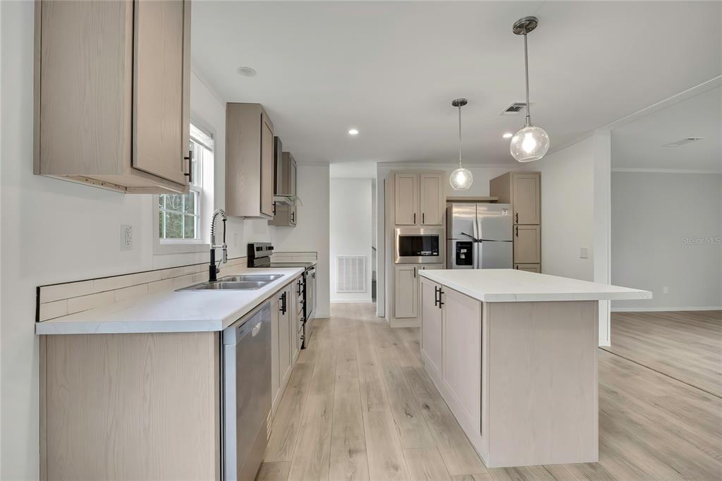5342 South Isabel Terrace Homosassa, FL 34446 - Photo 7 of 23 a kitchen with a sink a counter top space stainless steel appliances and cabinets