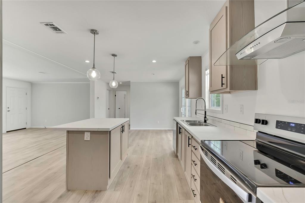5342 South Isabel Terrace Homosassa, FL 34446 - Photo 8 of 23 a kitchen with kitchen island a sink stainless steel appliances and cabinets