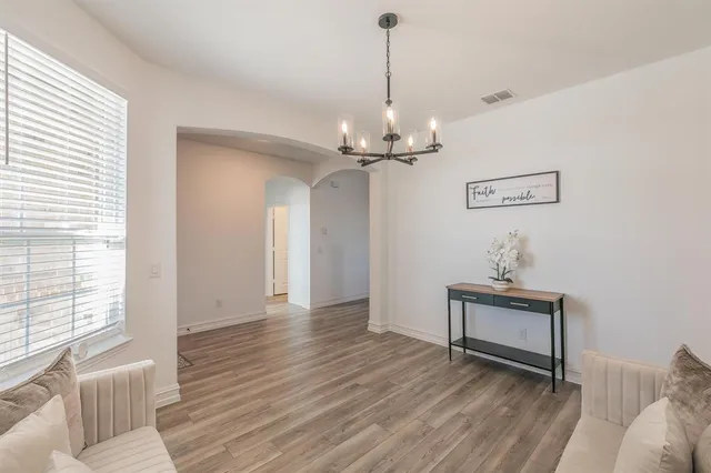 a kitchen with stainless steel appliances and wooden floor