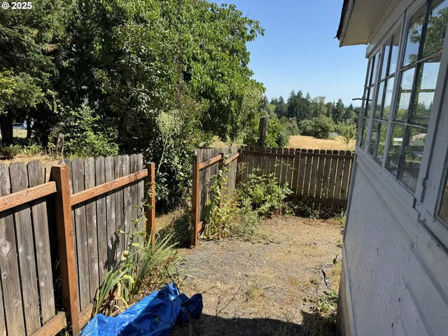 a view of wooden fence and a yard