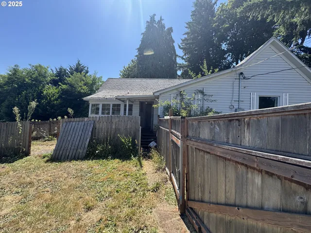 a view of a yard with large trees