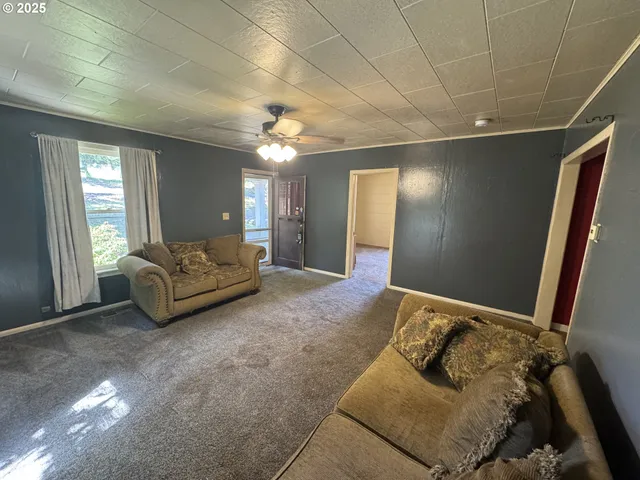 a spacious bedroom with a bed and a mirror