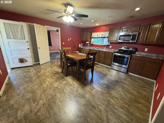 a kitchen with stainless steel appliances granite countertop a stove refrigerator and a sink