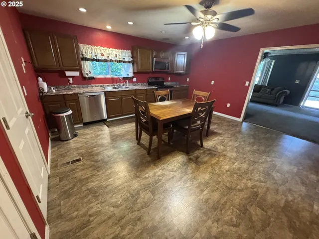 a kitchen with a stove a refrigerator and a fireplace