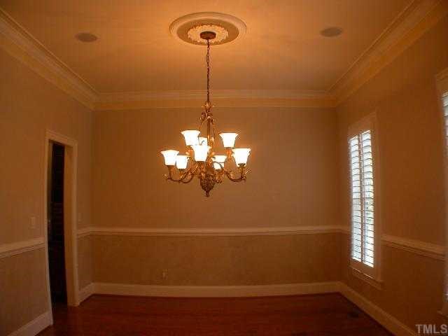 1922 Kirkwood Ridge Drive Raleigh, NC 27612 - Photo 4 of 12 a view of a room with a chandelier fan and wooden floor