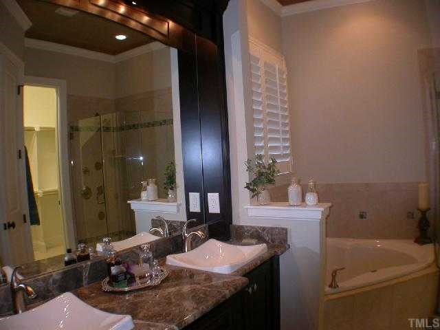1922 Kirkwood Ridge Drive Raleigh, NC 27612 - Photo 5 of 12 a bathroom with a sink and a mirror
