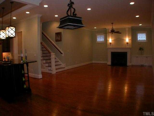 1922 Kirkwood Ridge Drive Raleigh, NC 27612 - Photo 7 of 12 an empty room with wooden floor and windows
