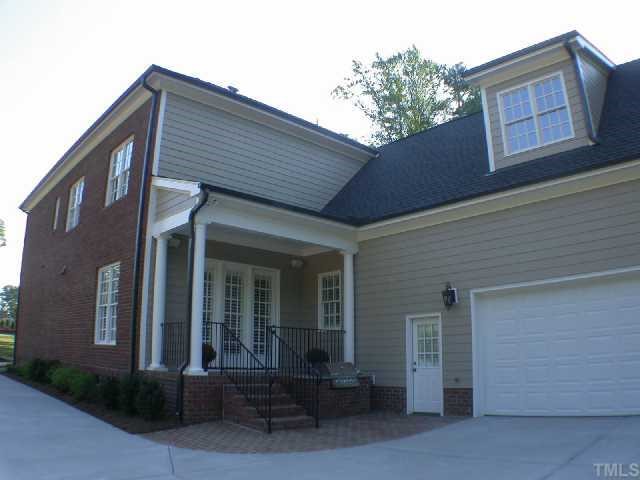 1922 Kirkwood Ridge Drive Raleigh, NC 27612 - Photo 10 of 12 a front view of a house with outdoor seating and a garage