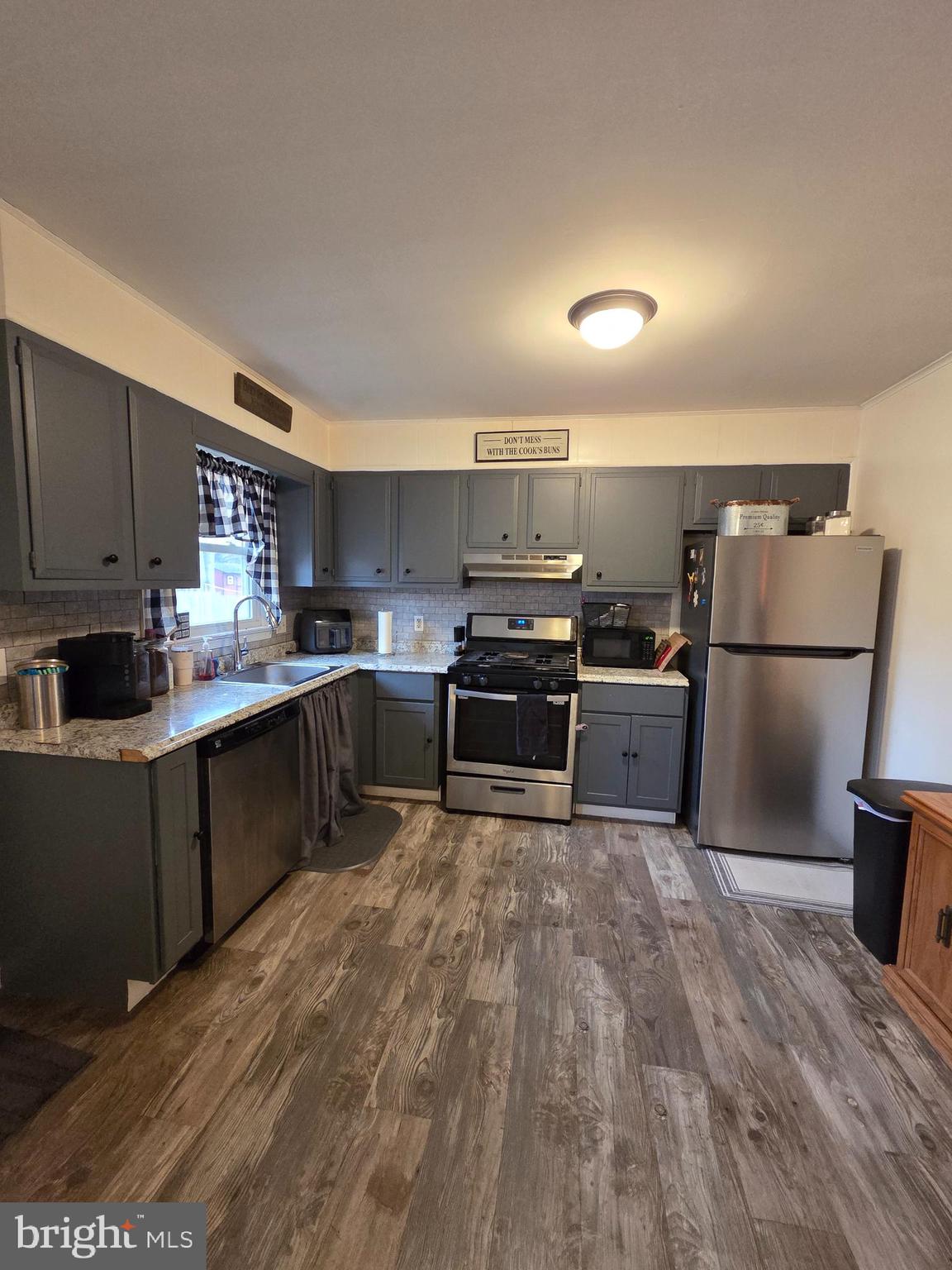 64 Rosedale Drive Bridgeton, NJ 08302 - Photo 5 of 16 a kitchen with refrigerator cabinets and wooden floor