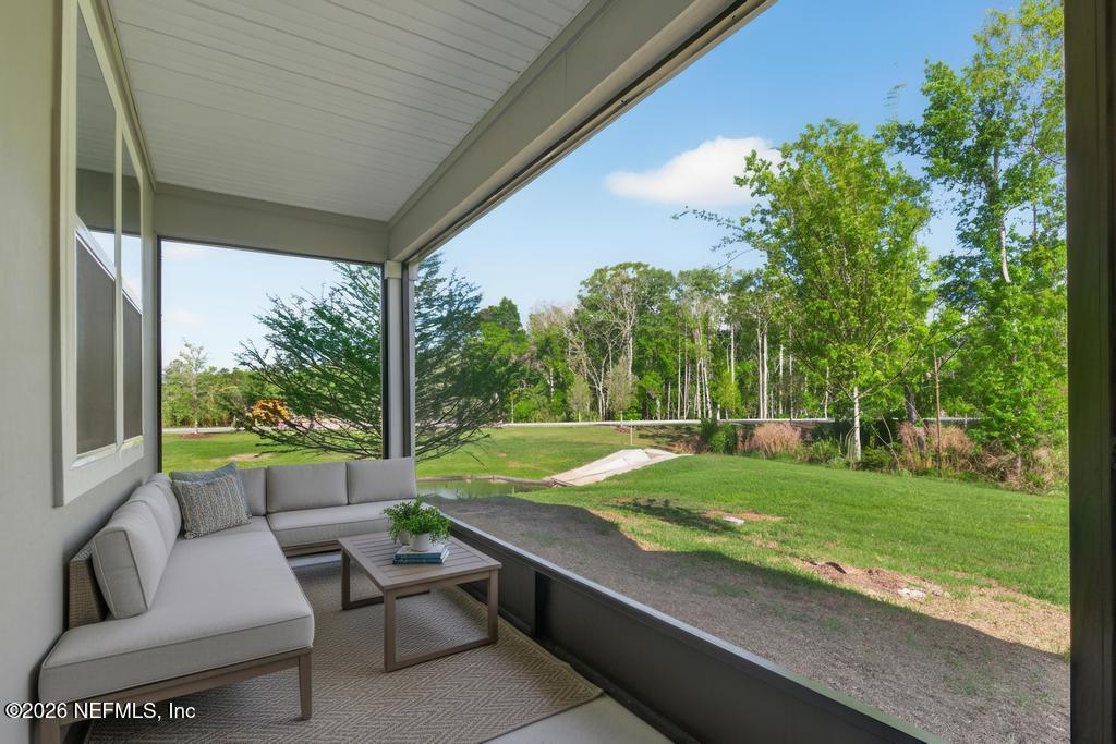 45 Seaport Breeze Road St. Augustine, FL 32095 - Photo 76 of 88 a view of a patio with couches plants and large trees