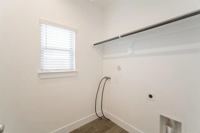 a view of closet with wooden floor