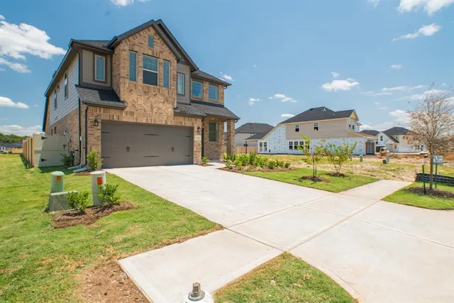 a view of a white house with a yard and table and chairs
