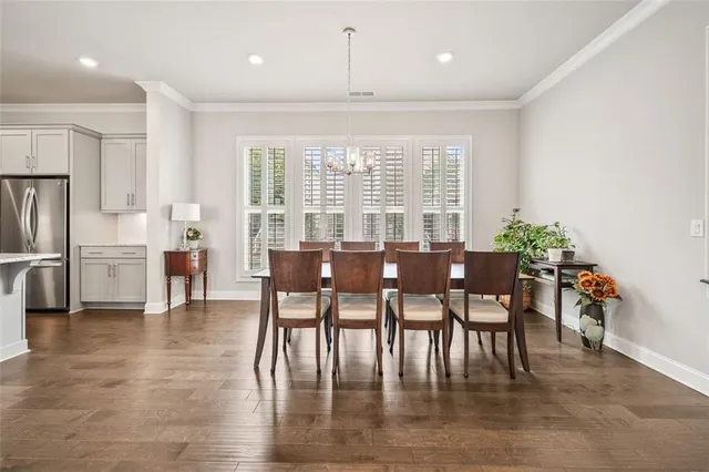 a large kitchen with kitchen island a sink a center island stainless steel appliances and a window