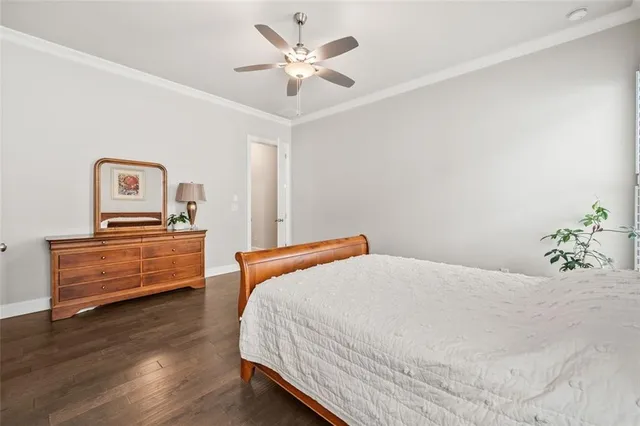 a white toilet sitting next to a white wall