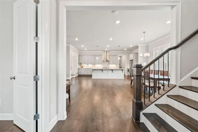 a view of a kitchen with wooden floor and electronic appliances