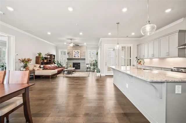a living room with fireplace furniture and a large window