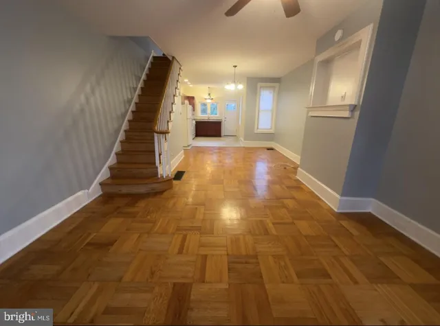 a view of entryway and hall with wooden floor